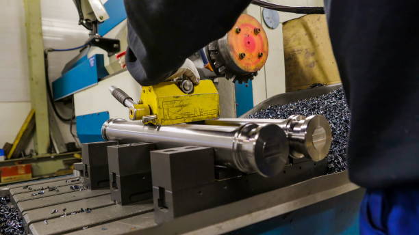 istock The worker placed the two metal pipes on a machine 1133761966