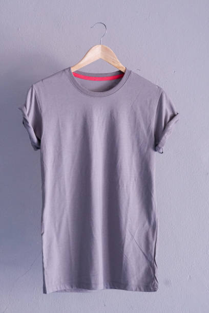 istock Retro fold grey cotton T-Shirt clothes mock up template on gray cement background concept for retail dress shop backdrop, Blank flat lay vintage grey wall plain laundry advertising 1133762618