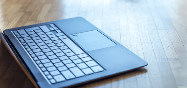 istock Laptop on the wooden floor, cut out 1133765531