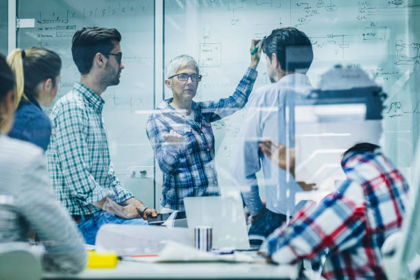 istock Female entrepreneur communicating with her team during a meeting in the office. 1133765709