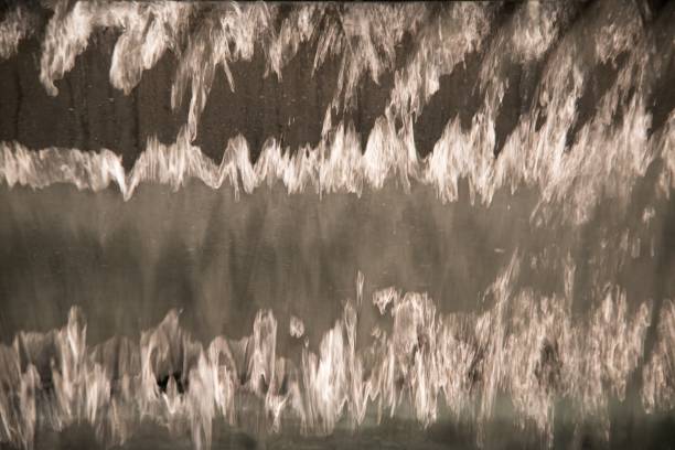 istock Close up of transparent falling water vertical flows. 1133765928