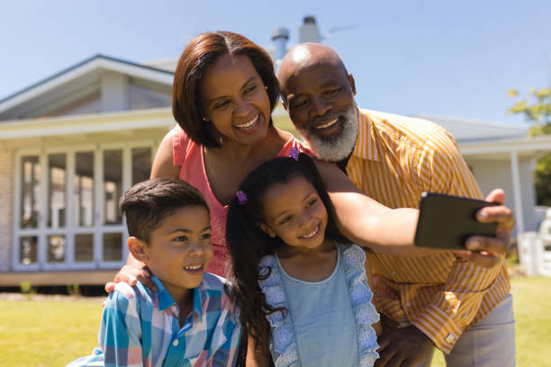 istock Multi-generation family taking selfie with mobile phone at the backyard 1133766562