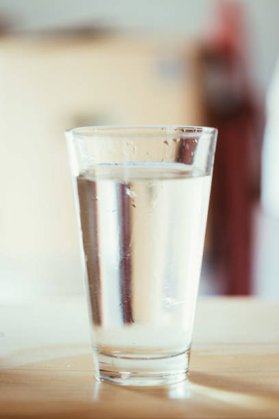 istock Glass of fresh cold water, blurry background 1133769046