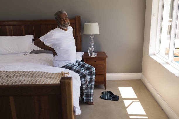 istock Senior man suffering from back pain in bedroom 1133769365