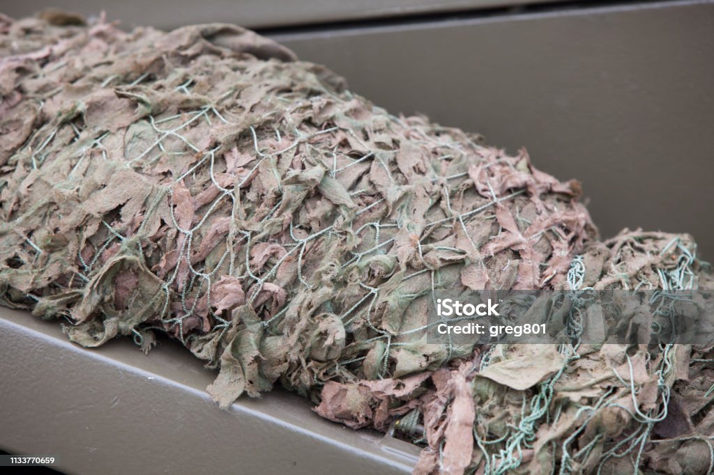 Collapsed military camouflage material Rolled material military camouflage Abstract Stock Photo
