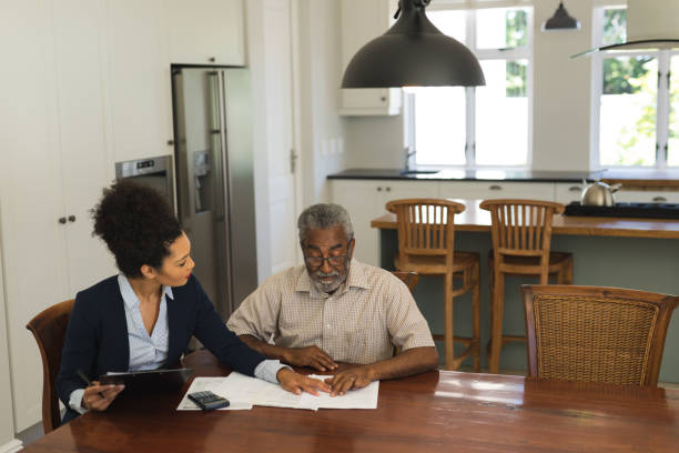 istock Senior man and real estate agent discussing over documents 1133772310
