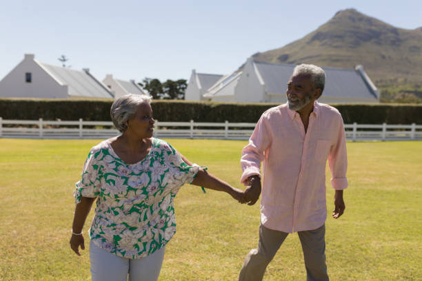 istock Senior couple walking hand in hand in the backyard 1133773301