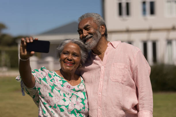 istock Senior couple taking selfie with mobile phone in the backyard 1133773369