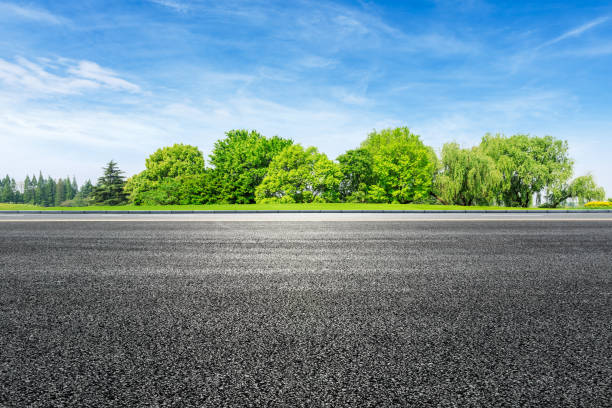 istock Asphalt road and green forest under blue sky 1133774960