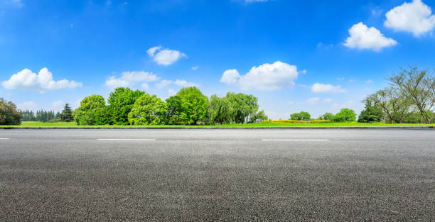 istock Asphalt road and green forest under blue sky 1133775000