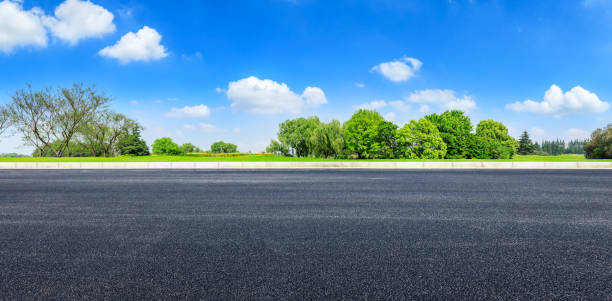 istock Asphalt road and green forest under blue sky 1133775001