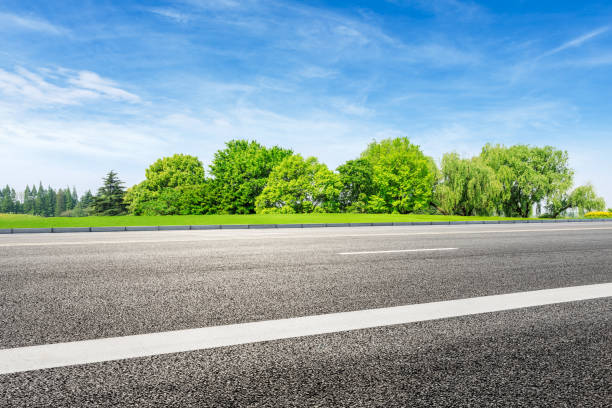 istock Asphalt road and green forest under blue sky 1133775022