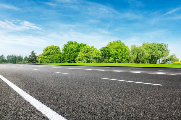 istock Asphalt road and green forest under blue sky 1133775023