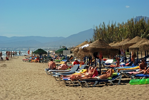 View of tourists relaxing on Playa de la Vibora beach, Elviria, Marbella, Malaga Province, Andalusia, Spain, Western Europe.