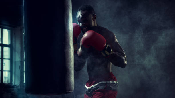 istock Hand of boxer over black background. Strength, attack and motion concept 1133777855