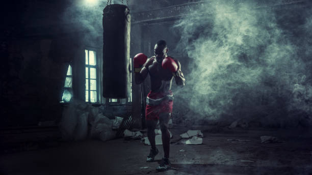 istock Hand of boxer over black background. Strength, attack and motion concept 1133777861