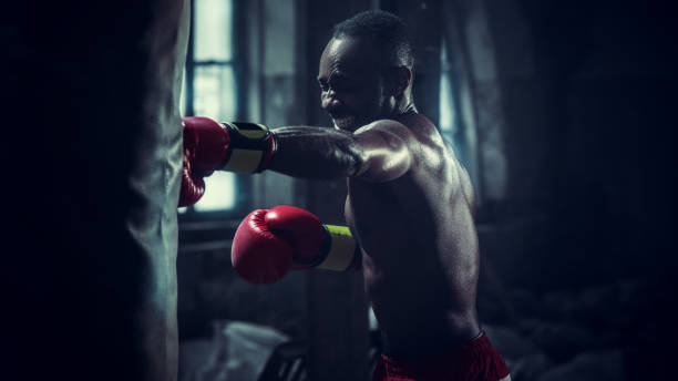 istock Hand of boxer over black background. Strength, attack and motion concept 1133777876