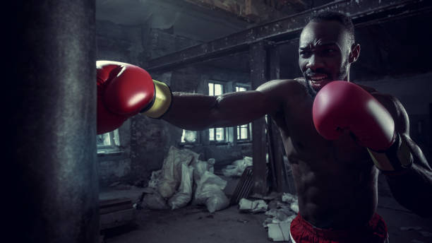 istock Hand of boxer over black background. Strength, attack and motion concept 1133777877