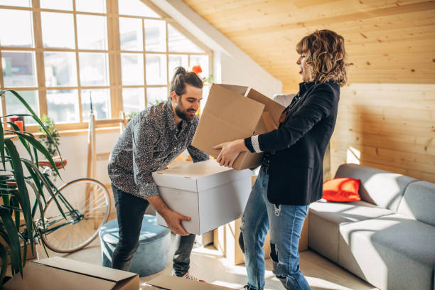 istock Young couple unpacking boxes in new home 1133778028
