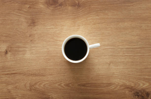 istock coffee cup over wooden table . top view 1133778249