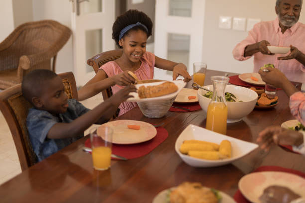 istock Multi-generation family having meal together on dining table 1133778378