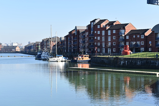 A view of Princes Reach residential apartments overlooking the water at Preston dock on a sunny day.