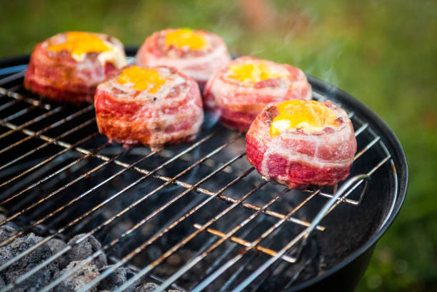 istock Making home made Beer Can Bacon Burgers on barbecue grill. 1133780819
