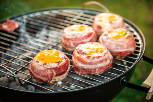 istock Making home made Beer Can Bacon Burgers on barbecue grill. 1133780840