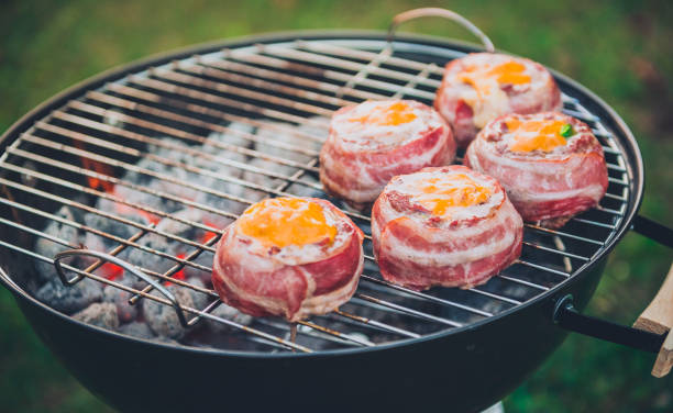 istock Making home made Beer Can Bacon Burgers on barbecue grill. 1133780852