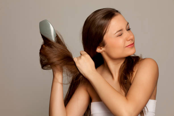 istock young girl has a problem with combing hair on gray background 1133781035