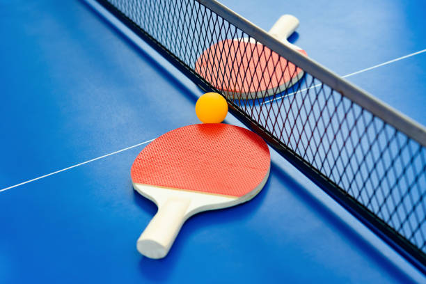 istock pingpong rackets and ball and net on a blue pingpong table 1133781517