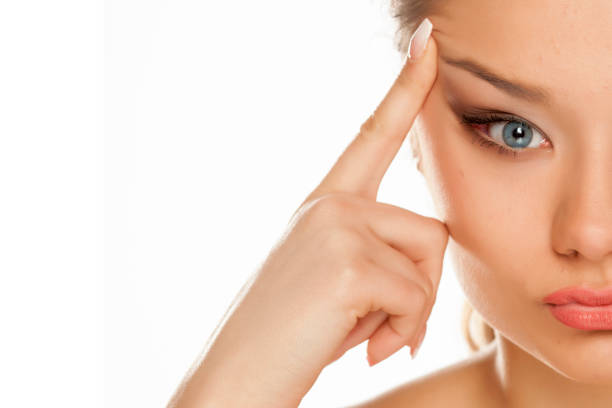 istock young girl rising her eyebrow on white background 1133781926