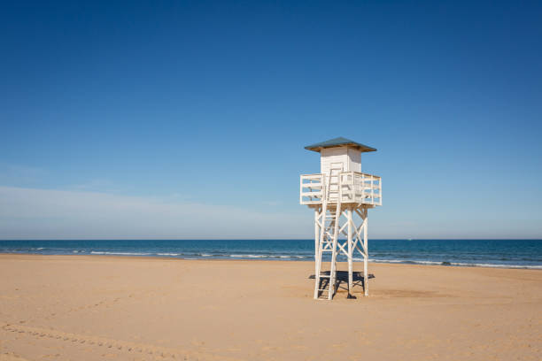 istock Lifeguard watch tower on empty beach. 1133782060