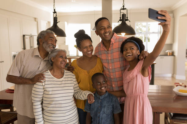 istock Multi-generation family taking selfie with mobile phone at home 1133782166