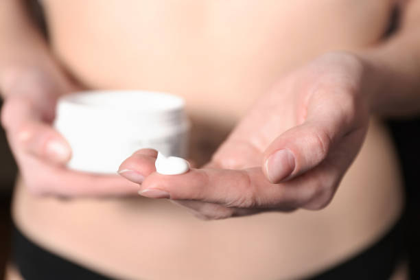 istock girl holds moisturizer for body 1133782251