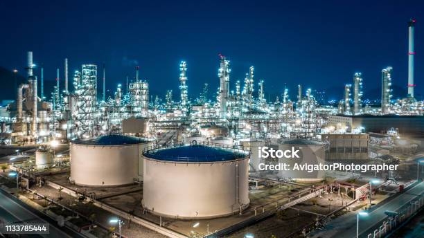 Oil Refinery Plant From Industry Zone Aerial View Oil And Gas Industrial Refinery Factory Oil Storage Tank And Pipeline Steel At Night Stock Photo - Download Image Now