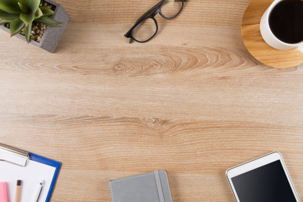 Above view of office desk with office supplies digital tablet and a coffee with copy space