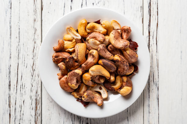 istock top view cashew nuts on a dish on white wood background 1133787371