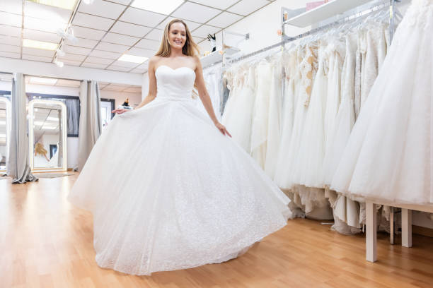 istock Content bride dancing in bridal shop 1133787682
