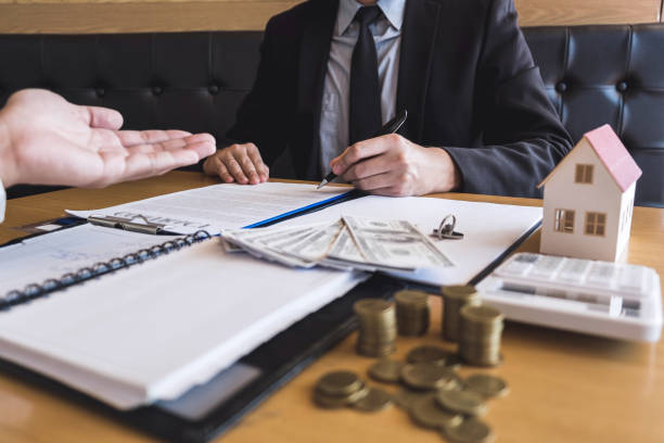 istock Estate agent broker presenting and wait to client after signing agreement contract real estate with approved application form, buying or concerning mortgage loan offer for and house insurance 1133788337