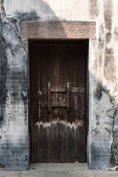 istock ancient wooden gate with two door lockers locked 1133788642