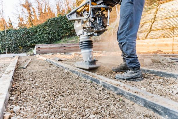 man using rammer tamper (jumping jack) for soil compacting - tamper imagens e fotografias de stock