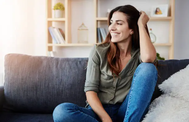 Shot of a beautiful young woman relaxing in the sofa at home