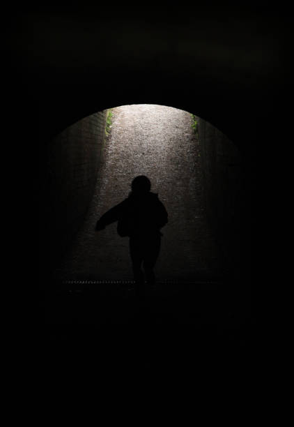 istock Young child running through a dark tunnel into the daylight 1133795491