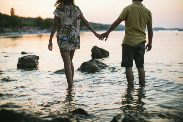 istock Hipster couple walking on beach 1133795930