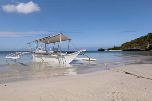 istock outrigger dive boat at the sea shore on the white sand 1133796723
