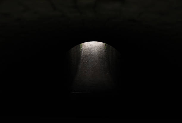 Light at the end of a dark tunnel landscape stock photo