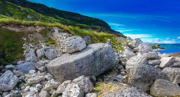 The big rocks on the coast in Cushendun village these big rocks are found near the road on the mountain side fronting the sea