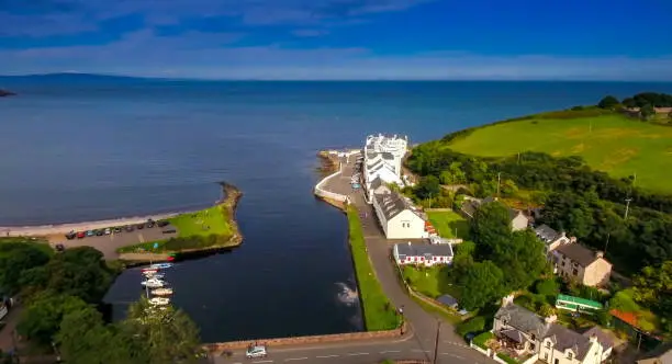 The aerial shot of the coastal village of Cushendun. Cushendun stands on an elevated beach at the outflow of the Glendun and Glencorp valleys.