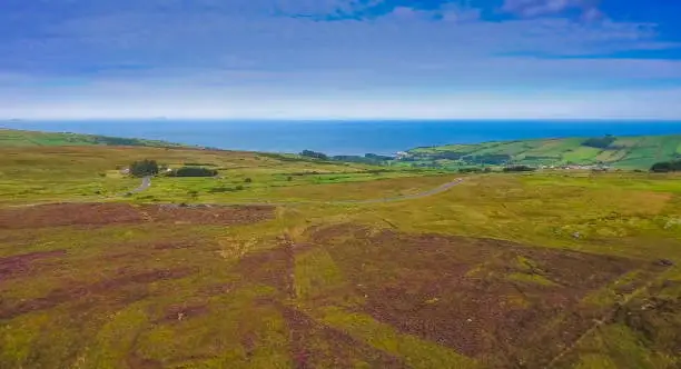 The landscape shot of the green valley in Cushendun. Cushendun stands on an elevated beach at the outflow of the Glendun and Glencorp valleys.